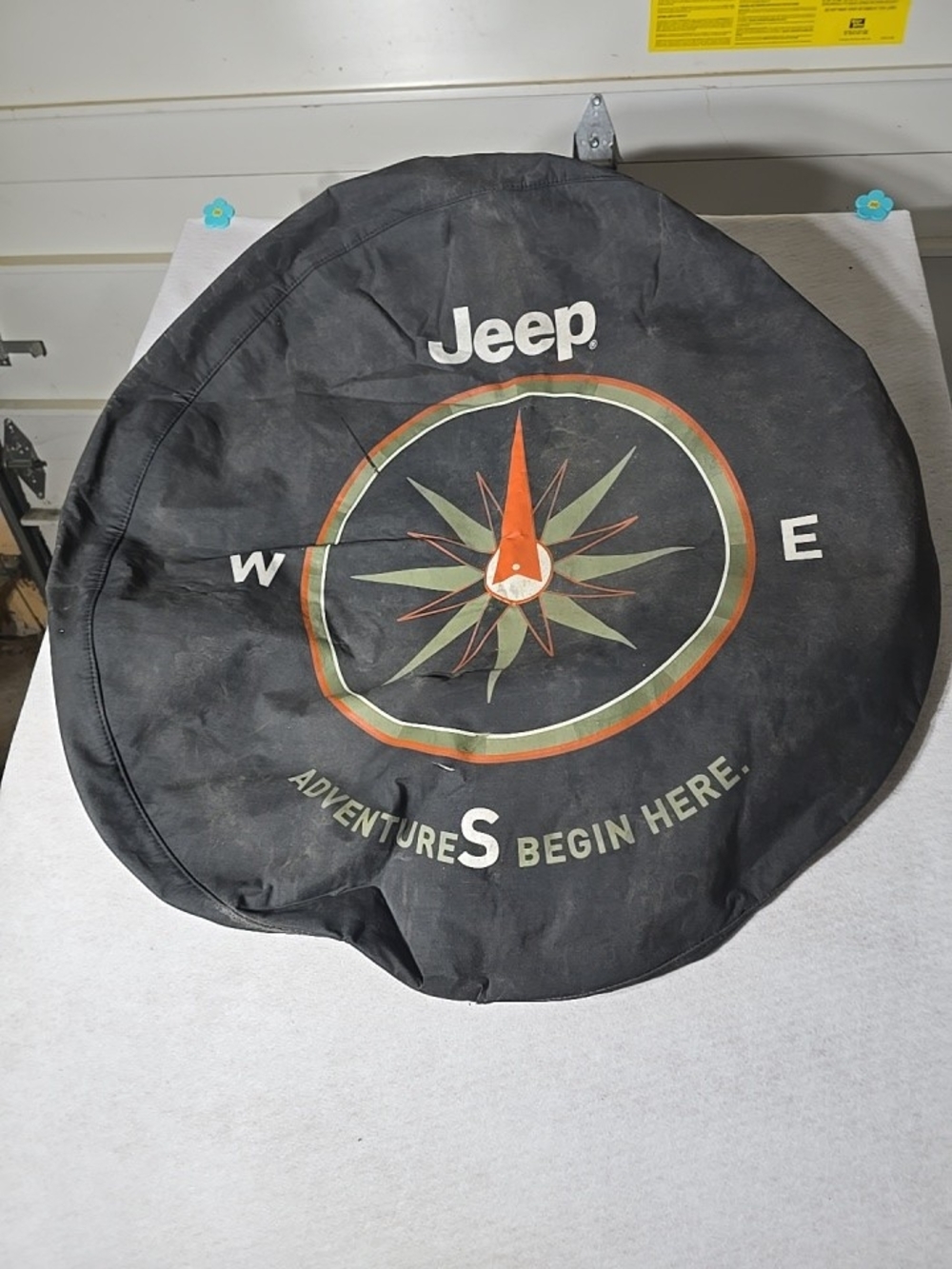 Jeep Black Spare Tire Cover with Orange Needle and Green Compass Points .